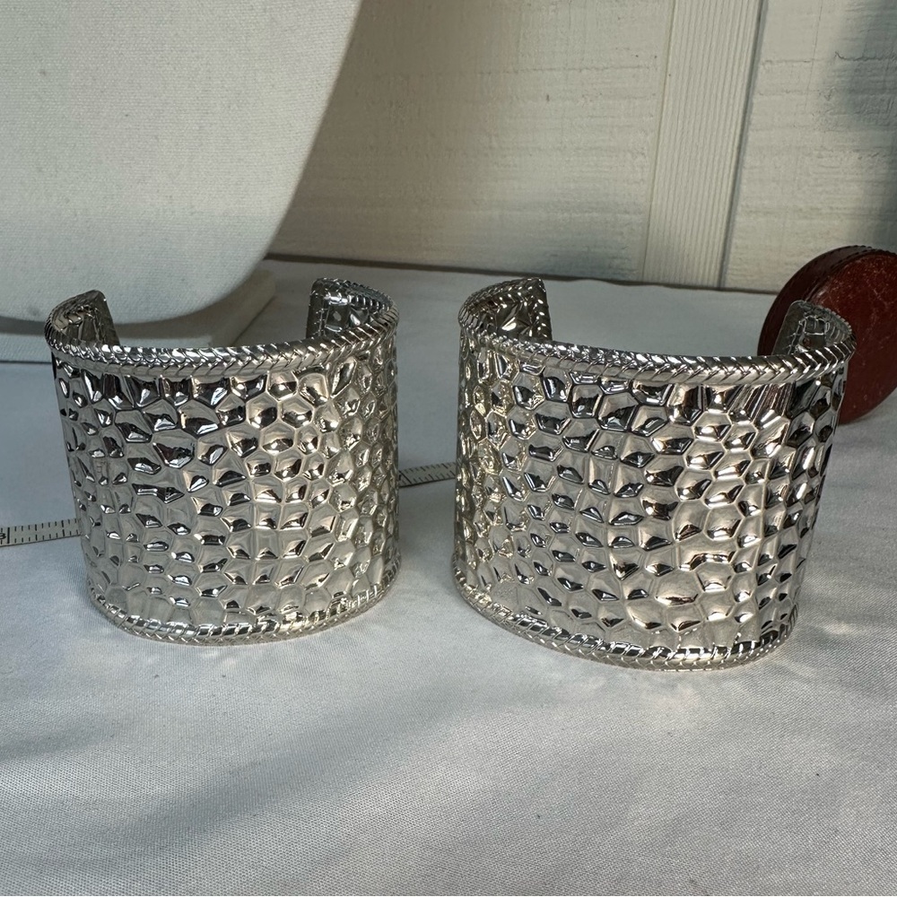 Two embossed silvertone cuff bracelets